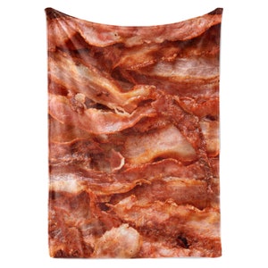 May include: A rectangular blanket featuring a close-up image of cooked bacon. The blanket displays layers of crispy, reddish-brown bacon strips with visible textures and variations in color, creating a realistic and appetizing appearance.
