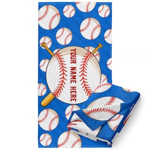 May include: A blue beach towel with a baseball pattern. A large baseball with crossed bats is in the center of the towel. The text "YOUR NAME HERE" is written on the baseball.