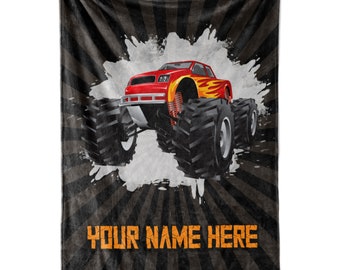 Puede incluir: Un camión monstruo rojo con llamas naranjas en el lateral está conduciendo sobre un fondo blanco y negro con un efecto de salpicadura blanca. El texto "YOUR NAME HERE" está en la parte inferior de la imagen.