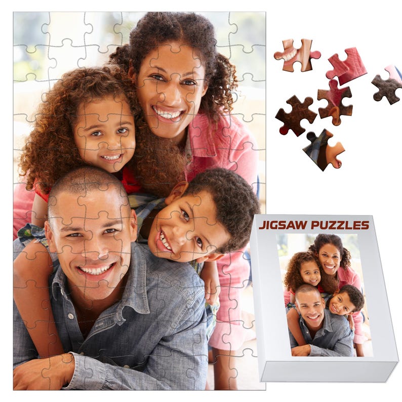 May include: A completed jigsaw puzzle featuring a family portrait, with a father, mother, and two children smiling. The puzzle is mostly assembled, with a few pieces separate. A box with the words "JIGSAW PUZZLES" is also visible.