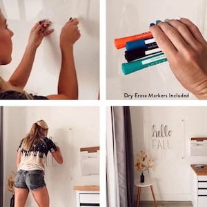 May include: A clear acrylic dry erase board with a wood frame is mounted on a white wall. A person is writing on the board with a black dry erase marker. The board is decorated with the words "hello fall" written in black. The board is accompanied by a set of colorful dry erase markers.