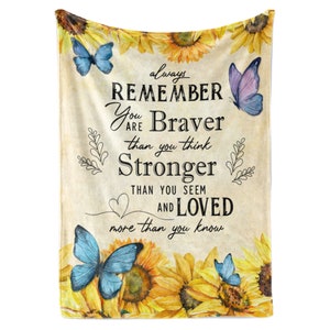May include: A soft, fuzzy blanket with a vintage background featuring sunflowers, butterflies, and the text "always remember you are braver than you think stronger than you seem and loved more than you know".
