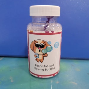 May include: A clear plastic bottle with a white lid and a label that says "Bacon Infused Blowing Bubbles". The label features a cartoon dog blowing bubbles with a magnifying glass.