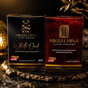 May include: Two rectangular perfume boxes by Miksalmina. The left box is black with gold text reading White Oud, 6ml, and Long Lasting. The right box is deep red with gold text reading 6ml/0.20 fl. oz., 100% Natural Perfume Oil, and Long Lasting.