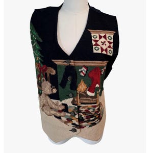 May include: A button-up Christmas-themed vest with a black collar and back. The front features a festive scene with a Christmas tree, teddy bear, fireplace, and stockings. The vest is beige at the bottom.