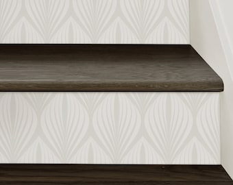 May include: A staircase featuring dark brown wood treads and white risers decorated with a repeating light gray leaf-like pattern. The wood grain is visible on the horizontal steps, while the vertical risers display a symmetrical design.