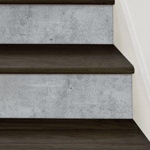 May include: Close-up of a set of stairs with dark brown wooden treads and light gray concrete risers.