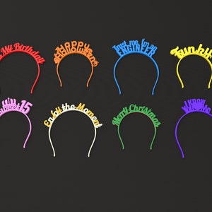 May include: Assortment of colorful headbands with various phrases, including "It's My Birthday", "Happy Queens", "Trust Me I'm an Engineer", "Funky", "Sweet 15", "Enjoy the Moment", "Merry Christmas", and "I Know You Love Me".