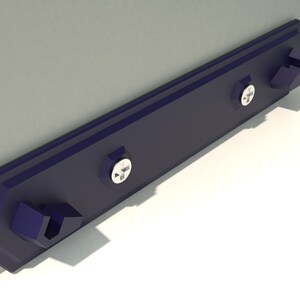 May include: A dark blue metal shelf bracket with two screw holes and two mounting tabs. The bracket is mounted to a wall.