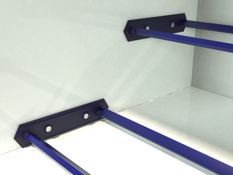 May include: Two blue metal shelf supports with screws attached to a white wall. The supports are designed to hold shelves in place.