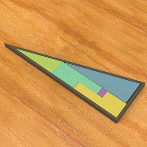 May include: A colorful wooden tangram puzzle in a triangular shape. The puzzle is composed of several geometric shapes in shades of green, blue, yellow, and purple, all contained within a dark brown frame. The puzzle is set on a wooden surface.