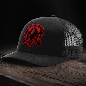 May include: Black and red trucker hat with a firefighter helmet and crossed axes logo. The logo says "Fire Department Rapids FD".