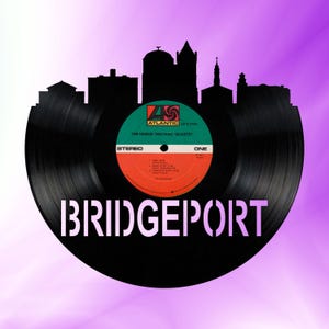 May include: A black vinyl record with a cityscape silhouette and the text "Bridgeport" in white. The record label features the Atlantic Records logo and the text "The Lennie Tristano Quartet" in white.