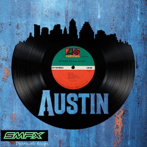 May include: Black vinyl record silhouette with a cityscape design. The record label reads "The Lennie Tristano Quartet." The word "Austin" is displayed in blue block letters. The background is a textured blue.