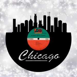 May include: A black vinyl record with a cityscape silhouette of Chicago, Illinois. The record label is red, green, and white with the text "The Lennie Tristano Quartet" and "Atlantic" in black. The record is titled "One" and has a stereo label.