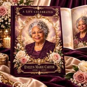Puede incluir: Un libro conmemorativo titulado A LIFE CELEBRATED con el retrato de una persona mayor de cabello gris rizado, chaqueta morada y collar de perlas. La portada tiene un marco dorado ornamentado, rosas blancas y dos palomas. Texto: EVELYN MARIE CARTER 1938 – 2025.
