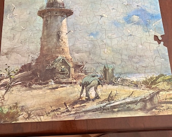May include: A watercolor painting of a lighthouse on a beach with a figure in the foreground. The lighthouse is tall and white with a black roof. The beach is sandy and there are some rocks and driftwood in the foreground. The sky is blue with white clouds. The painting is done in a realistic style.