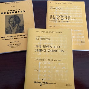 May include: Three yellow-colored books with the title "The Seventeen String Quartets" by Ludwig van Beethoven. The books are part of the Kalmus Study Scores series and are volumes 2 and 4 of the complete set.
