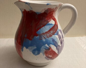 Hand painted milk or water pitcher. Abstract design on cream colored pottery.