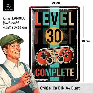 May include: A black metal sign with a retro video game controller design. The sign reads "LEVEL 30 COMPLETE" in colorful text. The sign measures 20 cm x 30 cm.