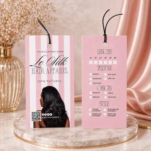 May include: Pink and white striped hair apparel tags with black text. The tags list hair lengths, textures, origins, and styles. One tag features a woman with long, black hair. The brand name is "Le Silk Hair Apparel."