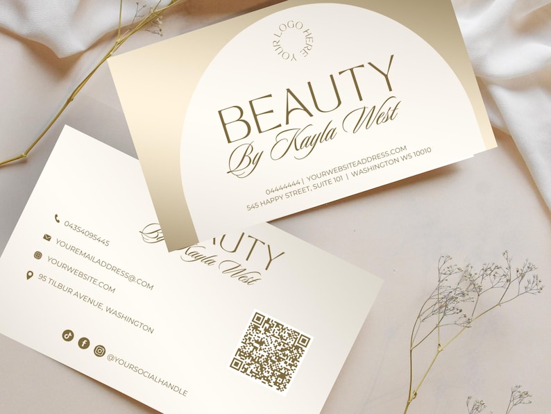 May include: A business card with a gold background and a circle with the text "BEAUTY By Kayla West" in gold. The back of the card has contact information and a QR code.