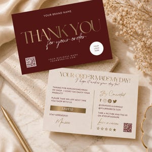 May include: A rectangular dark maroon thank you card with gold text reading THANK YOU for your order, a QR code, and a white logo circle. Below it, a cream-colored card features the text YOUR ORDER MADE MY DAY, social media icons, and a QR code.