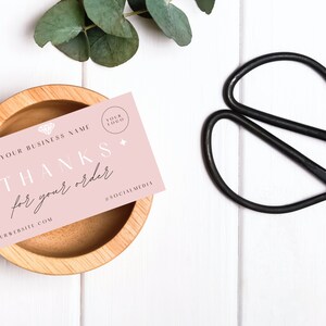 Puede incluir: Tarjeta de agradecimiento rosa con el texto "THANKS for your order" y las palabras "YOUR BUSINESS NAME" y "YOUR WEBSITE.COM" en texto negro. La tarjeta tambi&eacute;n tiene un icono de diamante y el texto "YOUR LOGO" en un c&iacute;rculo.