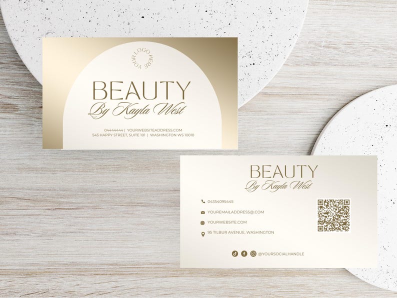 May include: Gold and white business card with the text "BEAUTY By Kayla West" and contact information. The back of the card has a QR code and social media icons.