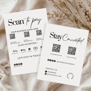 Op de afbeelding: Twee crèmekleurige visitekaartjes met zwarte tekst. Eén kaart leest "Scan to pay" en bevat QR-codes voor betalingsapps. De andere kaart zegt "Stay Connected" met een website en social media handles. De kaarten liggen op een neutrale achtergrond.