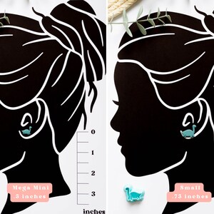 May include: Two images showing the size difference between two dinosaur earrings. The left image shows a smaller earring labeled "Mega Mini .5 inches". The right image shows a larger earring labeled "Small .75 inches".
