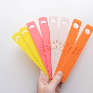 May include: A set of eight colour swatches in shades of yellow, orange, and pink. Each swatch has a rounded edge and the text "Echo Stone" printed on it.