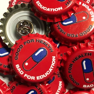 May include: Red bottle caps with a white pill design and the text "Good for Health, Bad for Education".