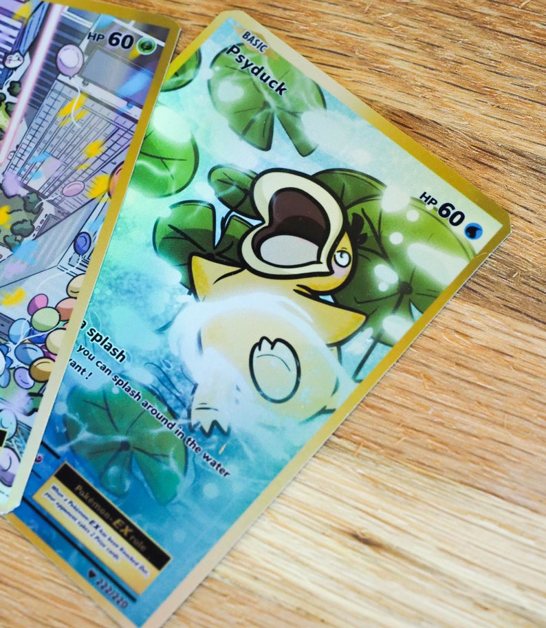 May include: A Pokemon trading card featuring Psyduck, a water-type Pokemon. The card is gold with a blue and green background. Psyduck is depicted with its mouth open and surrounded by lily pads. The card has a HP of 60 and the text 'BASIC Psyduck' is printed in the top left corner. The text 'splash you can splash around in the water 'ant!' is printed in the bottom left corner. The card also has the text 'Pokémon-EX rule' and 'EX' printed in the bottom left corner. The card number '222/220' is printed in the bottom right corner.
