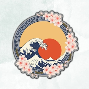 May include: A circular sticker with a gray border and a repeating geometric pattern. Inside the circle is a stylized image of a blue wave crashing over a red sun. Pink cherry blossoms are arranged around the circle.