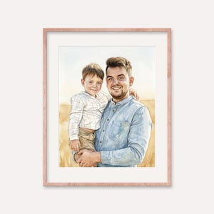 May include: Watercolor portrait of a man holding a child, both smiling. The man wears a light blue button-down shirt, and the child is in a white and light blue plaid shirt and khaki pants. The artwork is framed in a rose gold frame.