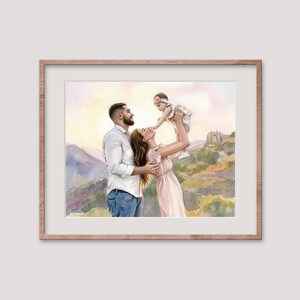 May include: Watercolor painting of a family of three, framed in a light brown wooden frame. The painting depicts a man, woman, and baby in a scenic outdoor setting. The family is embracing, with the baby being held up by the mother.