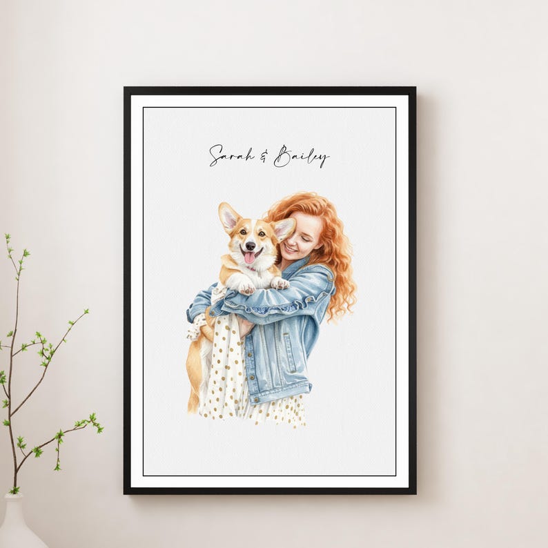 May include: Watercolor portrait of a woman with red hair holding a smiling Corgi dog. The woman wears a denim jacket and a white dress with small polka dots. The print is framed in a black frame, with the names "Sarah & Bailey" written at the top.