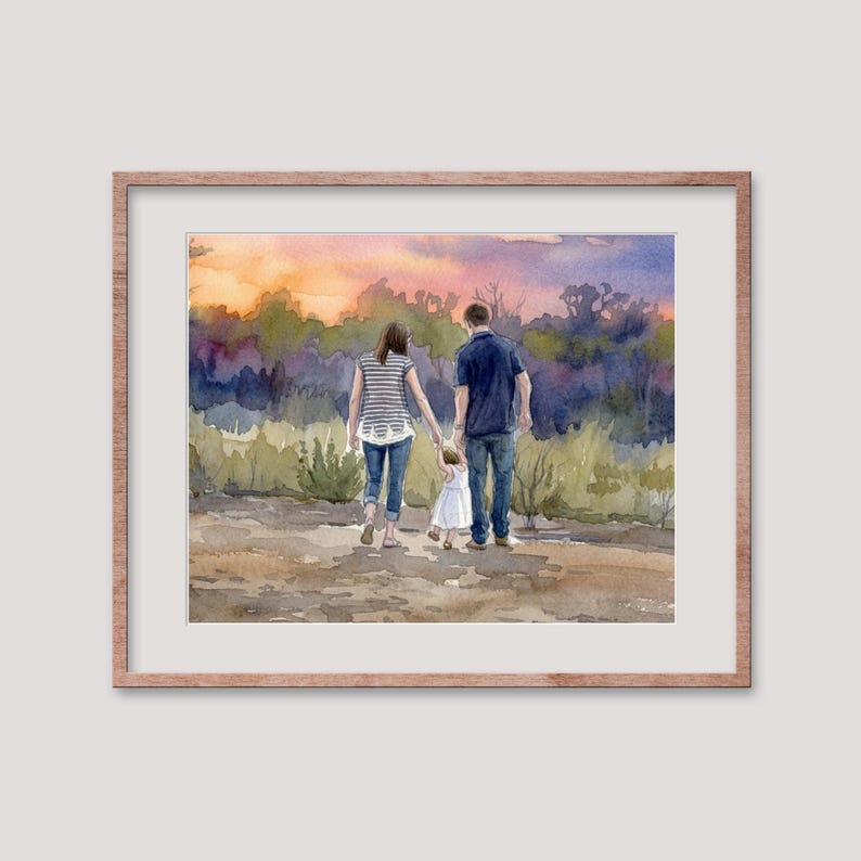 May include: Watercolor painting of a family walking away from the viewer, holding hands. The parents are wearing casual clothes, and the child is in a white dress. The background features a colorful sunset and trees, framed in a light brown wooden frame.