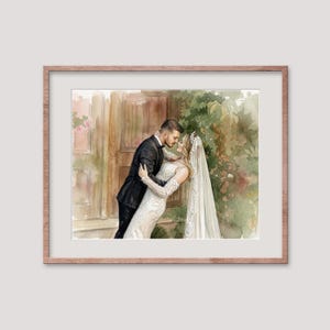 May include: Watercolor painting of a couple embracing, framed in a light brown wooden frame. The bride wears a white lace gown and veil, while the groom is in a black tuxedo. The background features a wooden door and greenery.