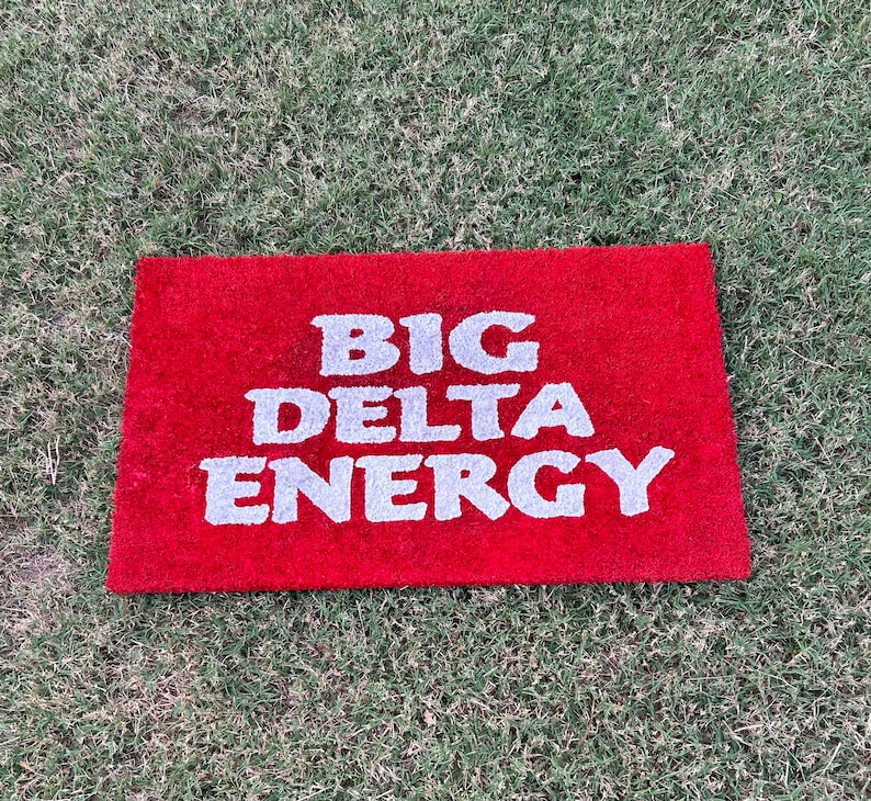 May include: Red doormat with the words "BIG DELTA ENERGY" in white lettering.
