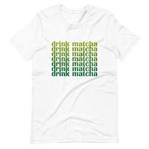 May include: White t-shirt with the text "drink matcha" repeated six times in a gradient of green and yellow.