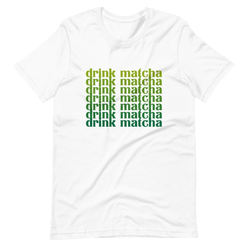 May include: White t-shirt with the text "drink matcha" repeated six times in a gradient of green and yellow.