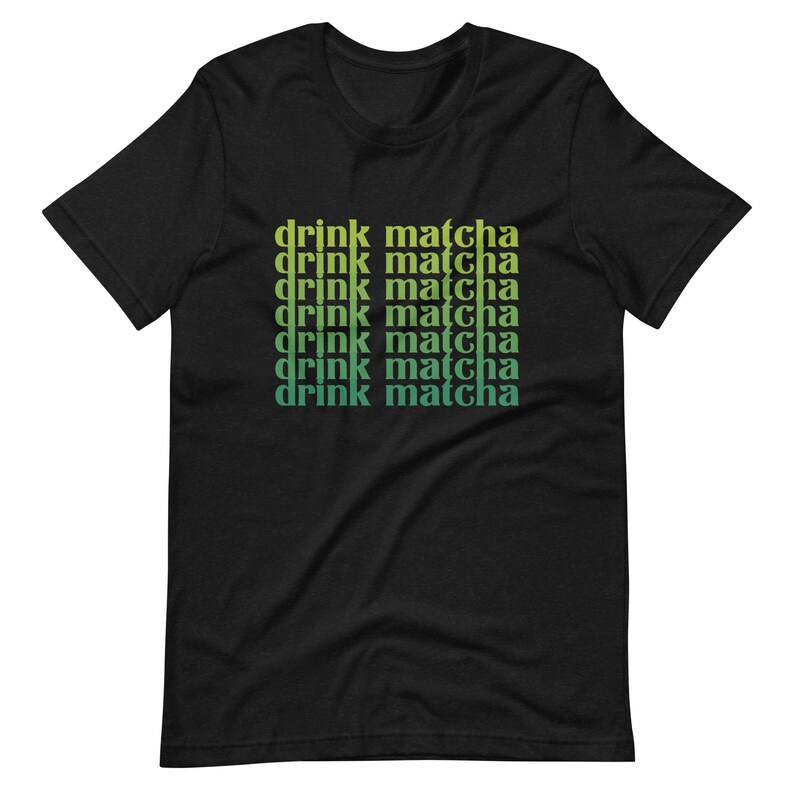 May include: Black t-shirt with the text "drink matcha" repeated in a gradient of green and yellow.