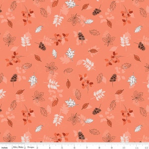 May include: Coral-colored fabric with a repeating pattern of autumn leaves and branches in shades of brown, white, and black. The design includes various leaf shapes and outlines, creating a seasonal theme. The fabric is measured in inches.