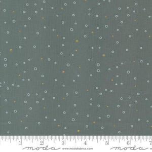 May include: A gray fabric with a white and gold polka dot pattern. The fabric has a subtle texture and a soft feel.