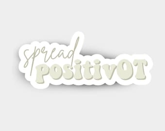 Puede incluir: Una pegatina verde claro con la frase "spread positivity OT". Las palabras están en una fuente manuscrita con un contorno blanco. La pegatina está sobre un fondo blanco.