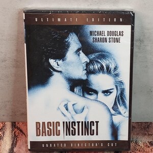 May include: DVD of the movie "Basic Instinct" featuring Michael Douglas and Sharon Stone. The cover has a blue-toned image of the actors and the text "Ultimate Edition" and "Unrated Director's Cut".