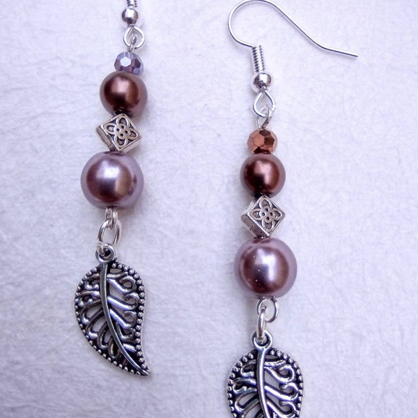 Caramel latte handmade drop earrings. In warm browns and bronzes with tibetan silver leaf charm. Also available in clip ons.