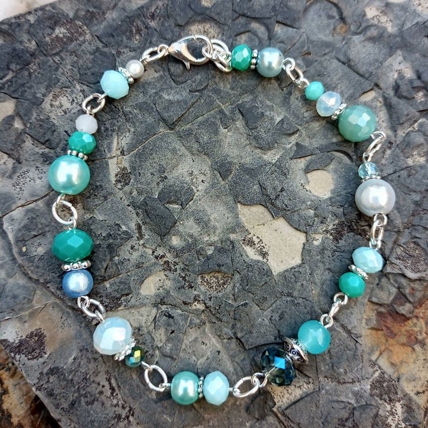 Seafoam splash handmade beaded bracelet. Lovely mix of aqua, sea green and opalescent glass crystals.